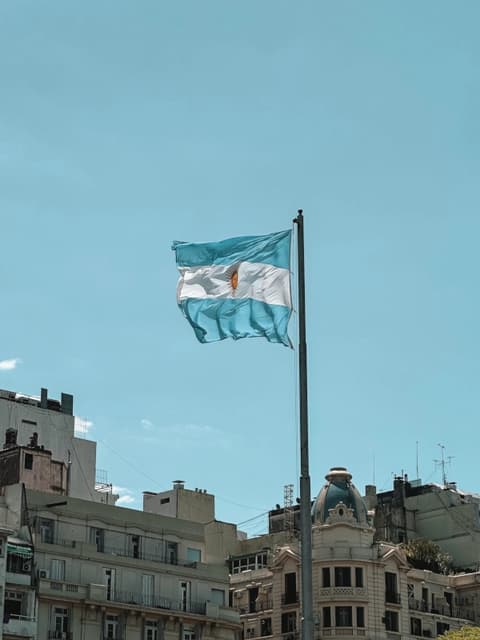 The Argentine flag flying above buildings in central Buenos Aires