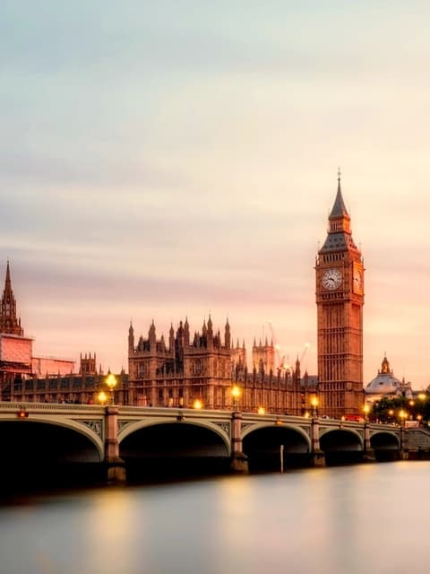 Big Ben and the Houses of Parliament beside Westminster Bridge at dusk
