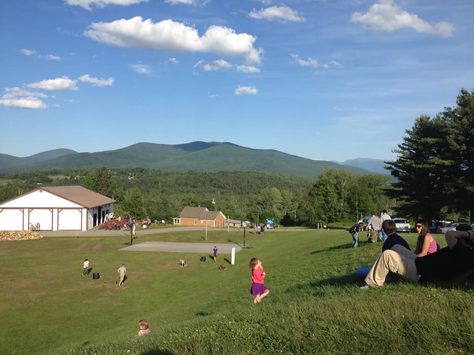 Families on the hillside lawn at PorcFest, the movement’s annual festival in Lancaster, New Hampshire