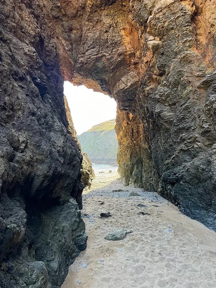 A natural rock arch over the beach on Sark’s shoreline