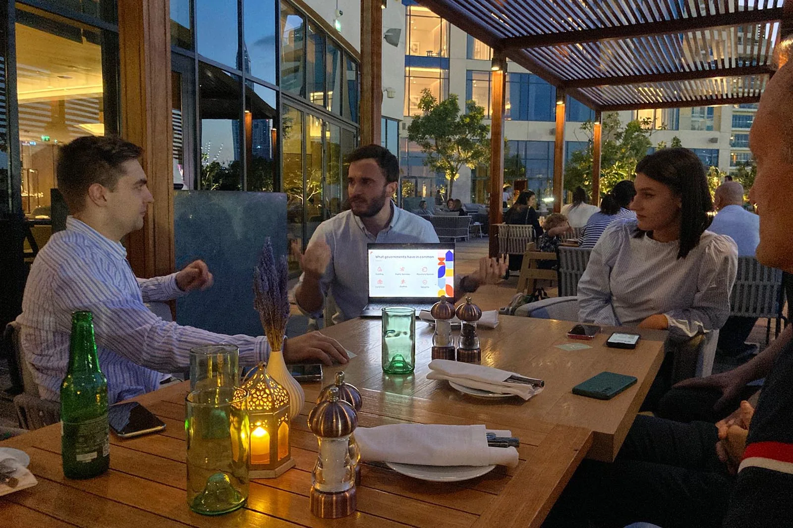 Attendees in conversation at an evening Free Cities meetup in Dubai
