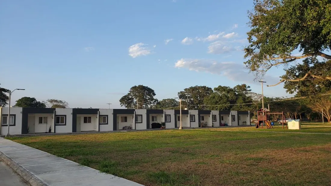 A row of completed homes along a green at Ciudad Morazán