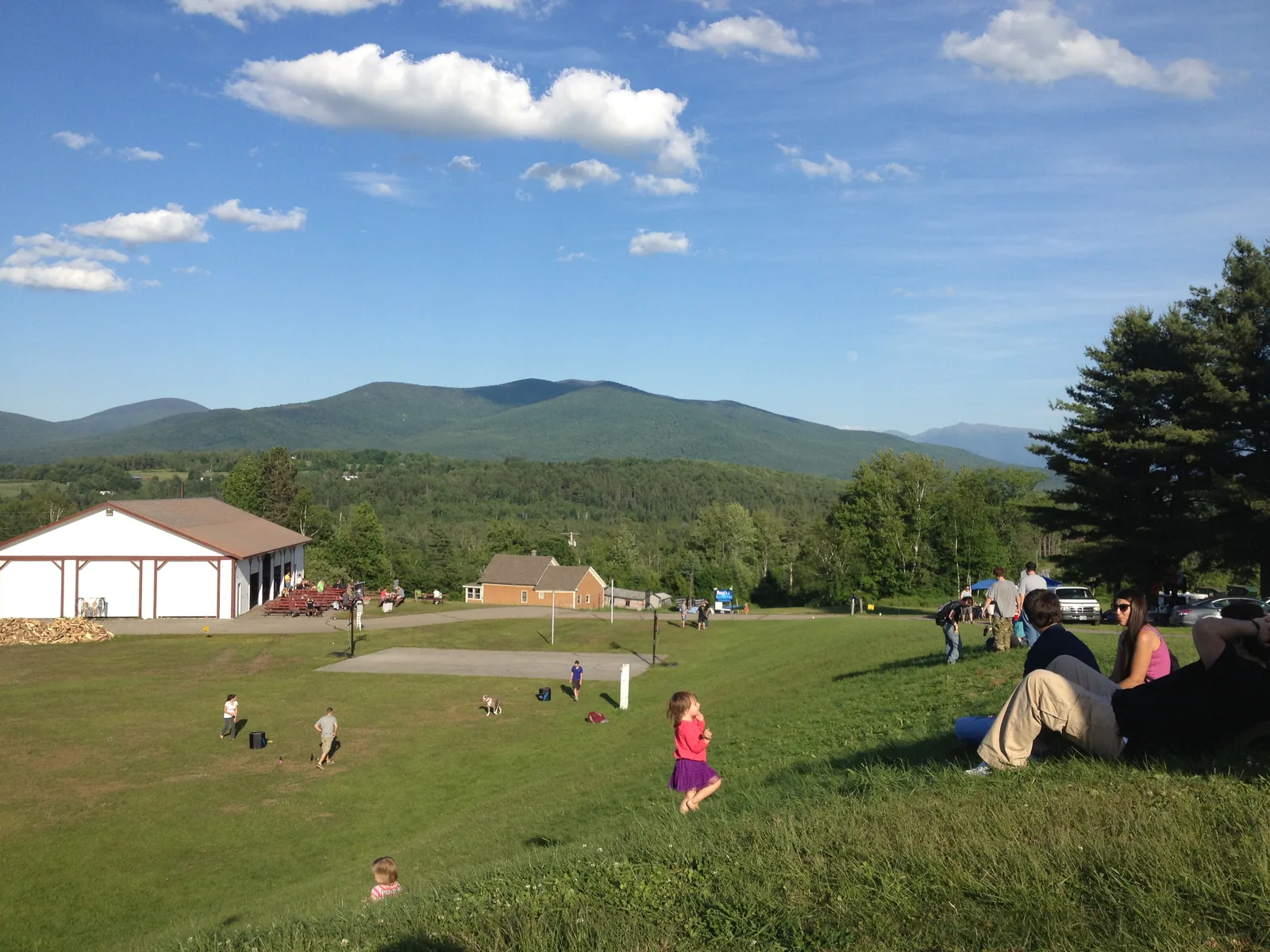 Families on the hillside lawn at PorcFest, the movement’s annual festival in Lancaster, New Hampshire