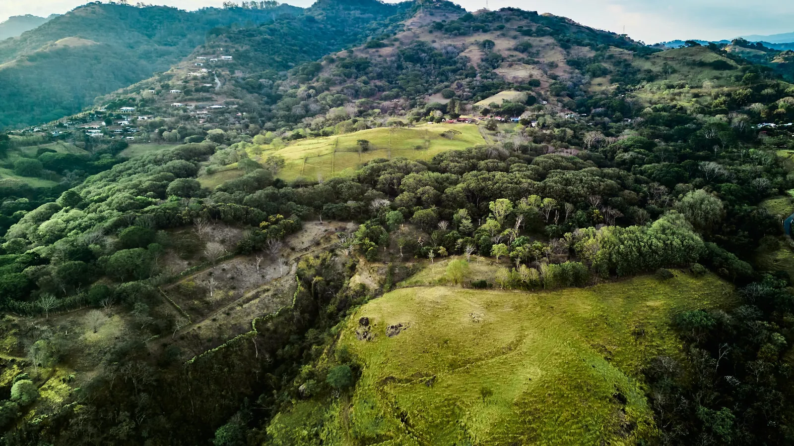Green hillsides and farmland on the Veritas Village site above Atenas, Costa Rica