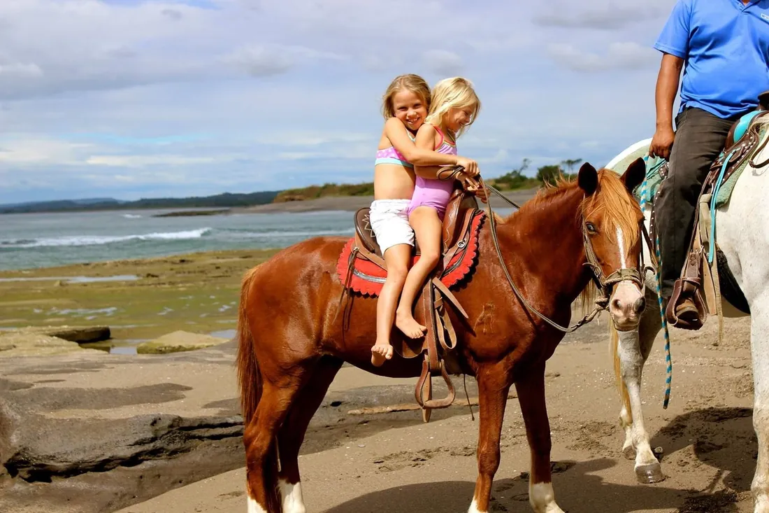 Riders on horseback along the beach at Playa Pacifica